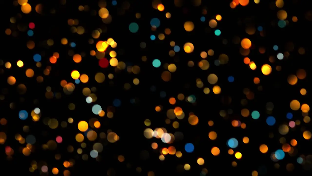 Animation of small round blue and orange particles in bokeh