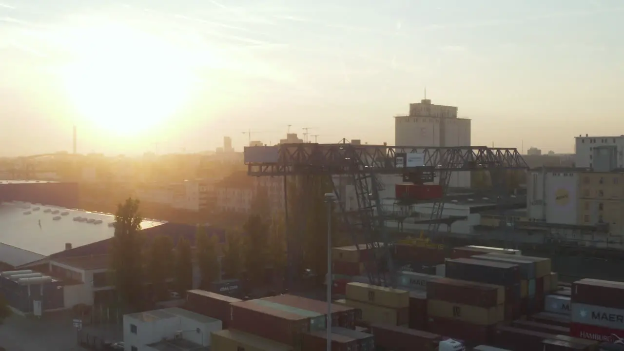 Port in Early Morning Sunrise with Cargo Containers and Cranes Aerial foward