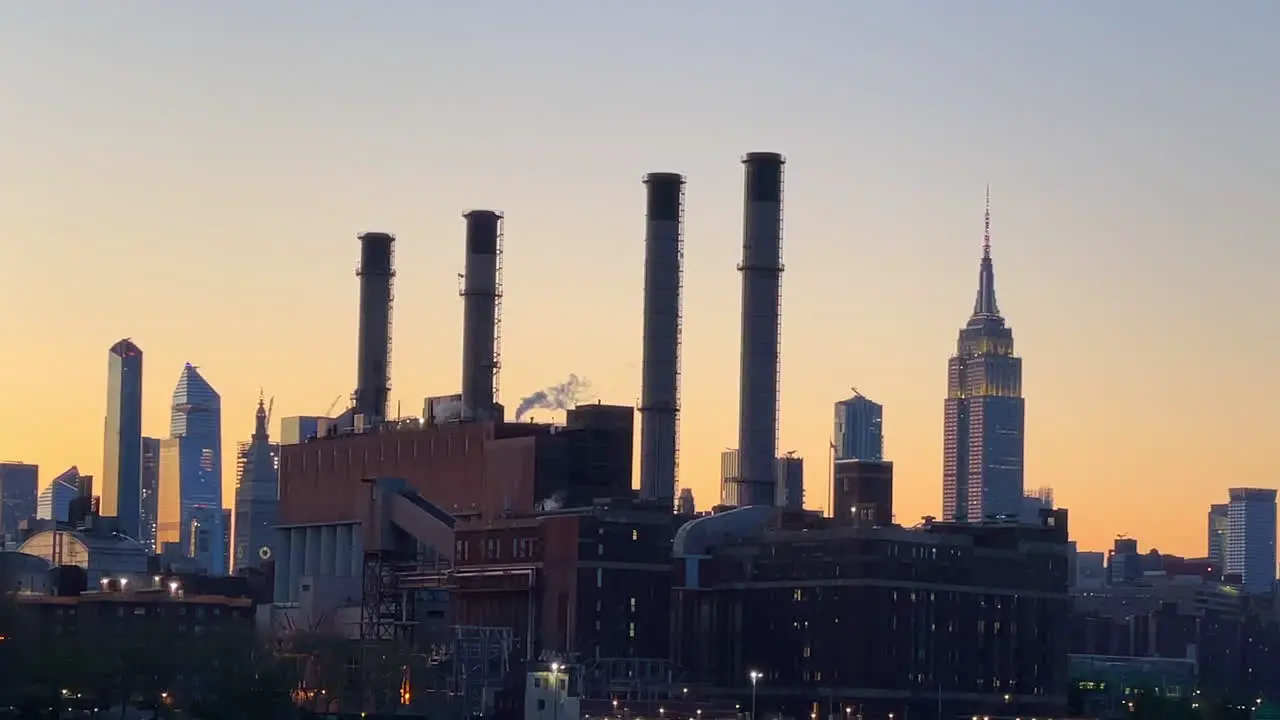 silhouetted New York City skyline cityscape at sunset golden hour view from Hudson River