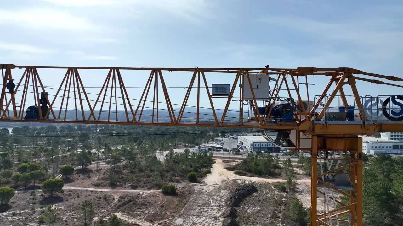 Drone shot flying sideways filming a construction crane closely