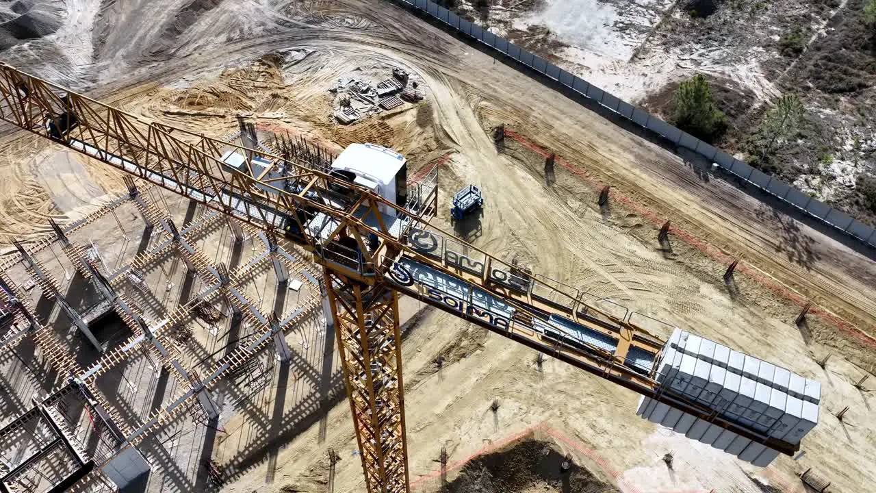 Drone shot from a construction site descending and tilting up