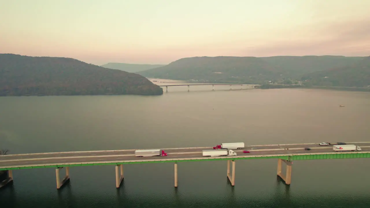 Fedex truck driver delivering goods Cinematic aerial of Tennessee River Bridge at sunset