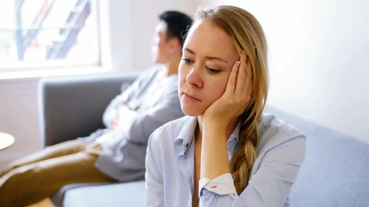 Man and woman upset with each other in living room