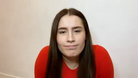 Young Female Student Looking Visibly Concerned While Talking to Camera On Video Call