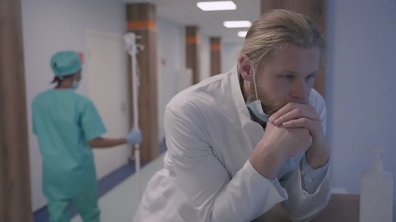 A Young Doctor With Long Blond Hair Is Very Stressed Out And Exhausted After A Difficult Day Of Bad News