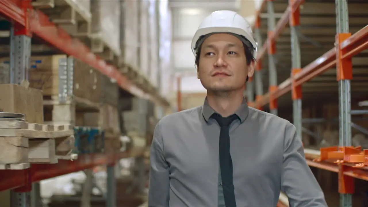 Businessman In Elegant Clothes In Warehouse Walking On Large Corridor In Factory