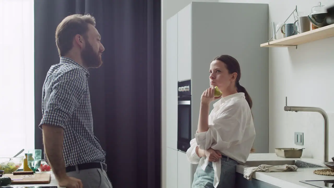 Happy Couple Chatting In A Modern Style Kitchen