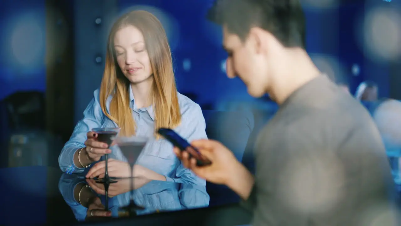 Young People Relax At A Table In A Cozy Restaurant While They Talk And Have A Good Time 4