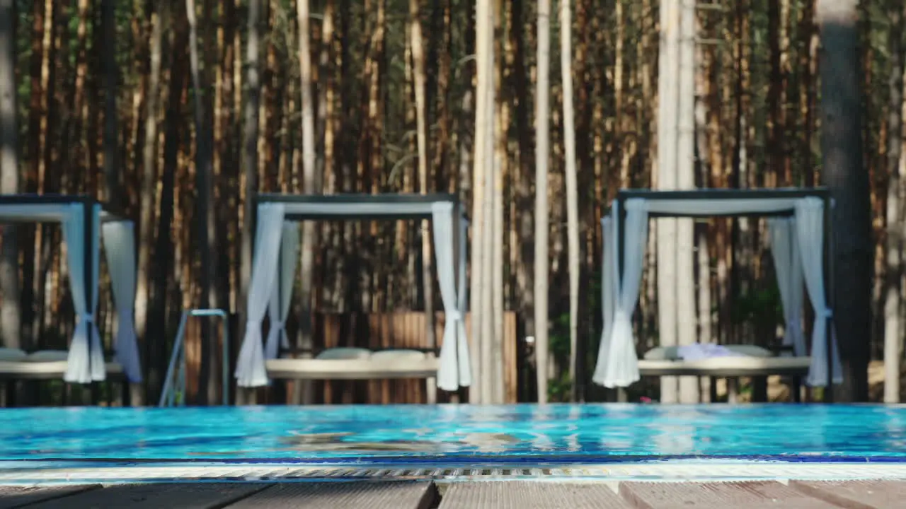 Happy Vacation A Man Enjoys Relaxing By The Pool Pulling Out Of The Water Slow Motion