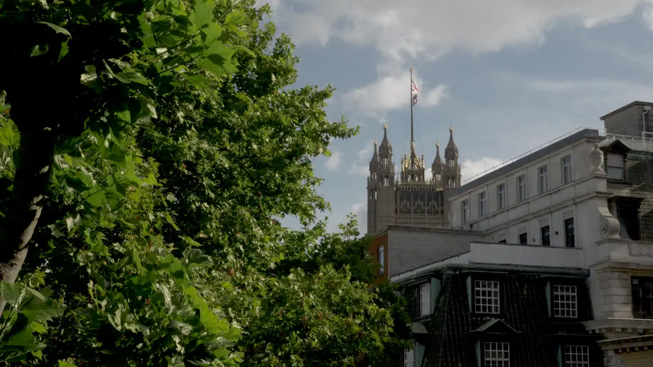 Distant shot of the Victoria Tower with a Union Jack flag fluttering in the wind at Westminster Palace on 14 June 2022