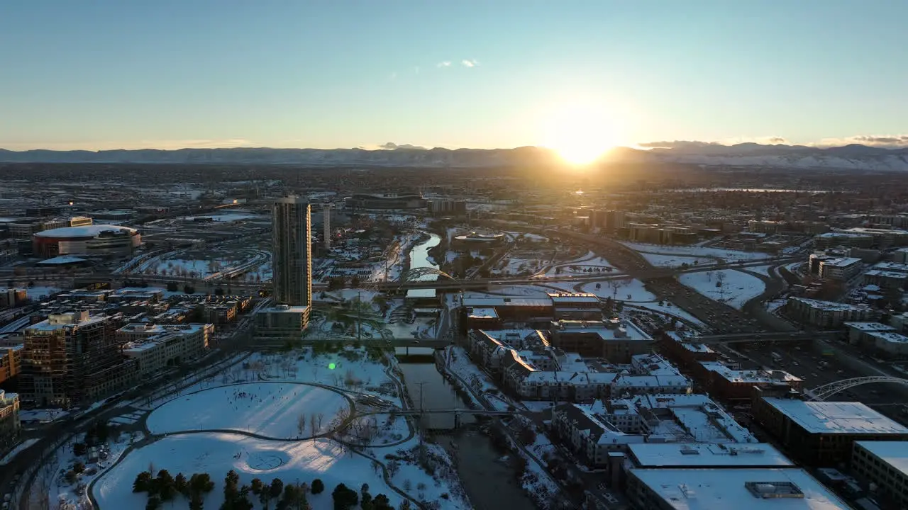 Aerial drone shot of sunset moving backwards over Commons Park Denver