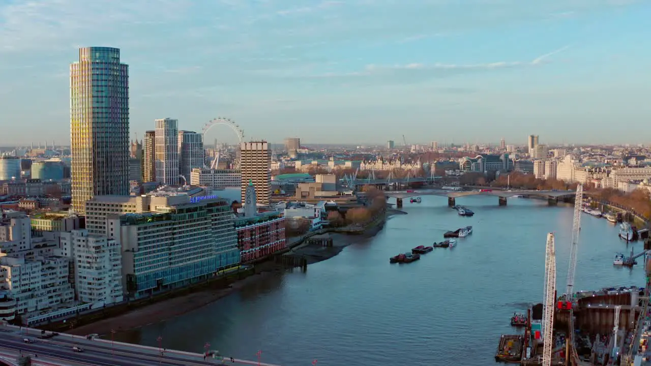 Aerial dolly forward drone shot over Blackfriars towards thames river London eye Westminster sunrise