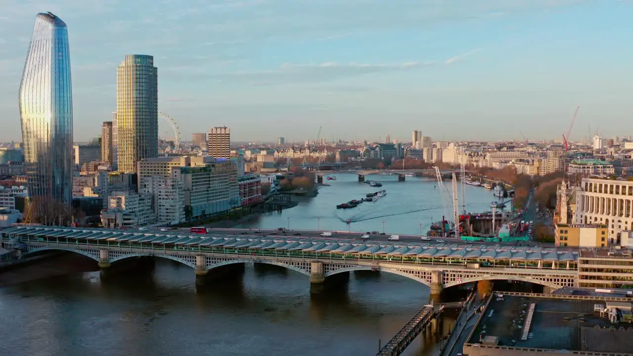 Aerial dolly forward looking west over Blackfriars bridge towards London eye and House of parliament London