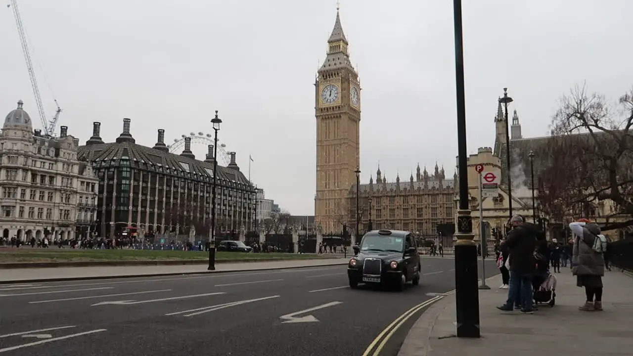 Classic London black taxi Cab with iconic Big Ben and Parliament Square in Background