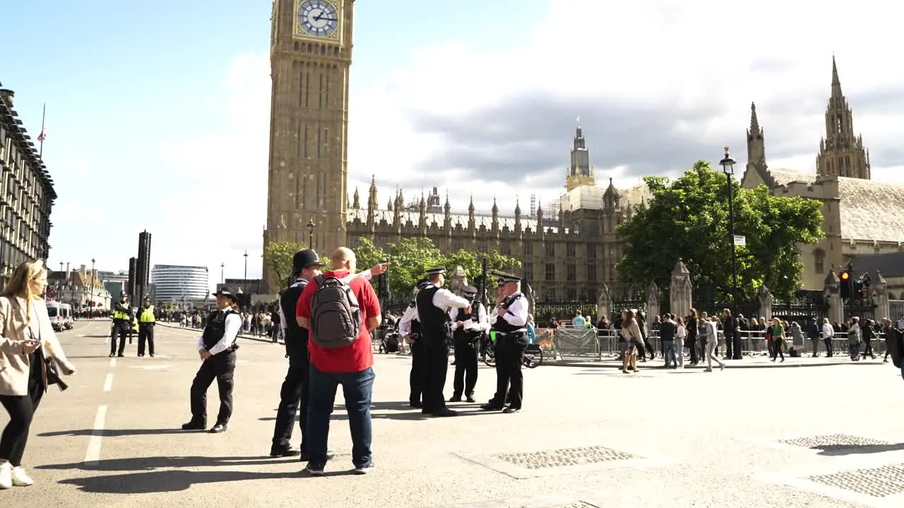 Slow motion shot of police officers cordoned off the roads in Parliament Square London UK on a sunny day