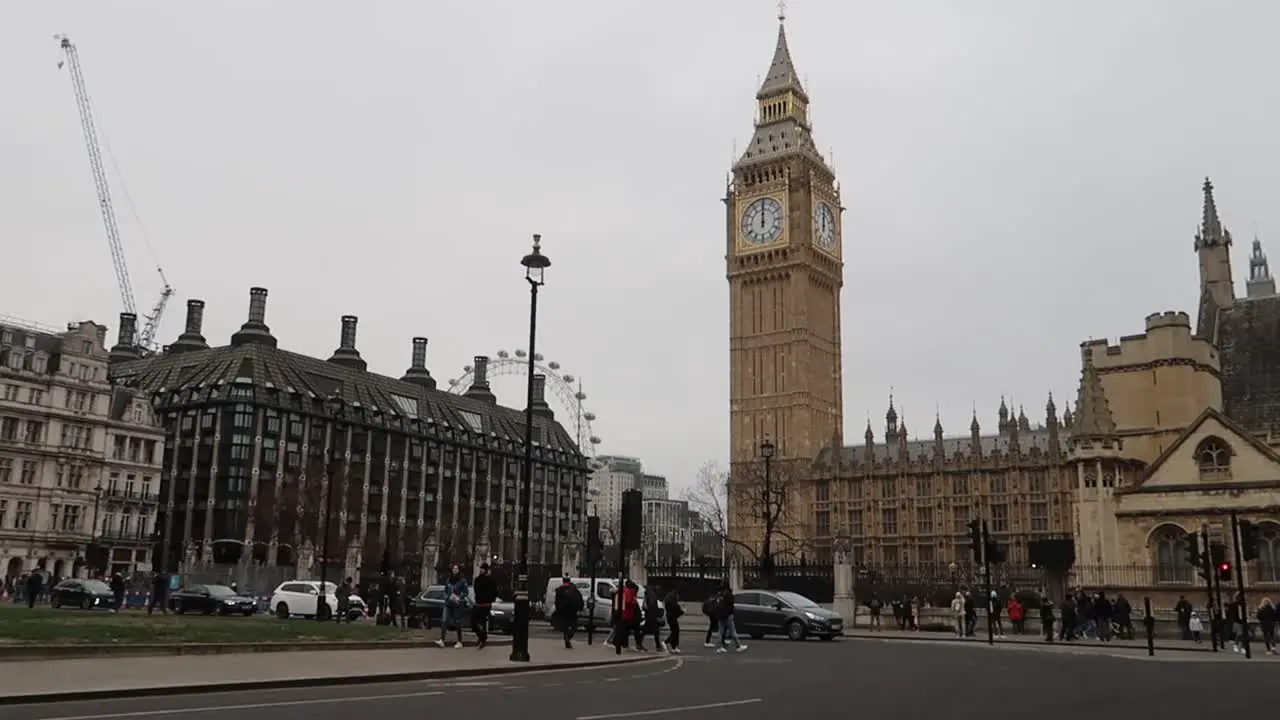 Parliament Street Traffic in London city center with Big Ben and pedestrian people in westminster