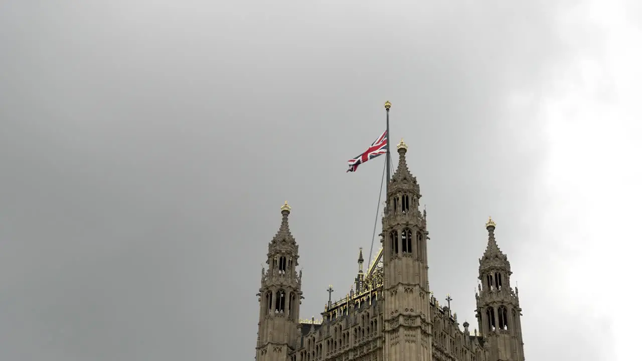 Shot of the top of Victoria Tower houses of parliament with clouds behind