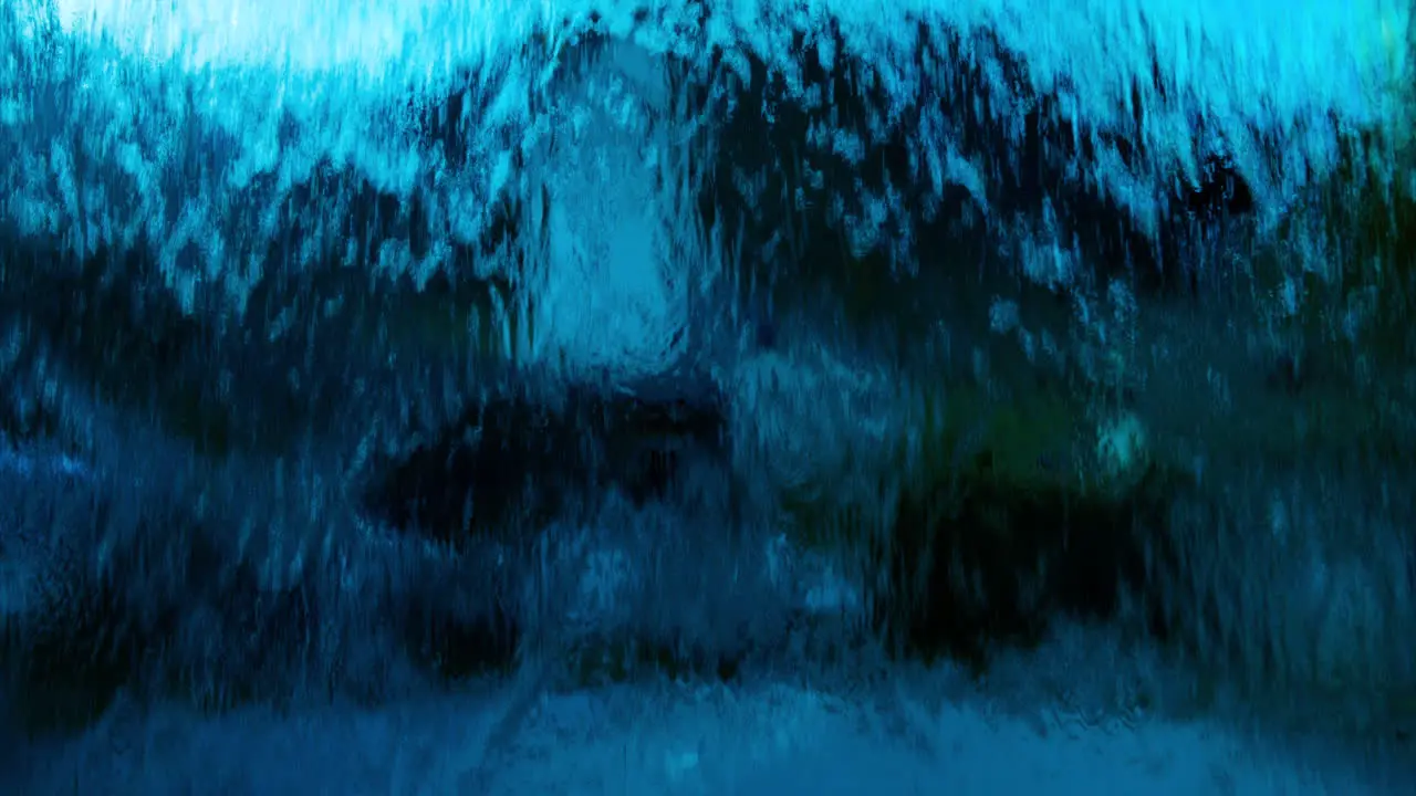 Abstract view of deep blue water flowing down over glass in front of camera view in village in Europe wide view