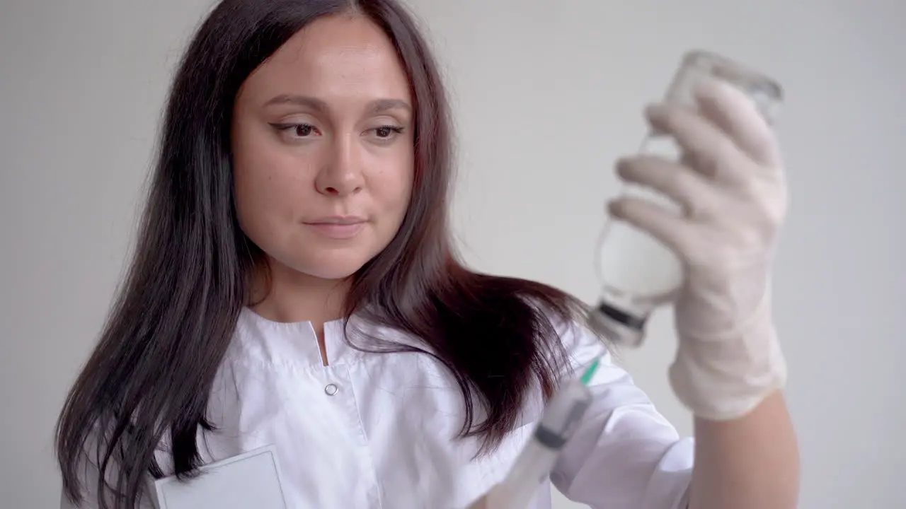 Portrait Of A Female Doctor Filling A Syringe With A Vaccine