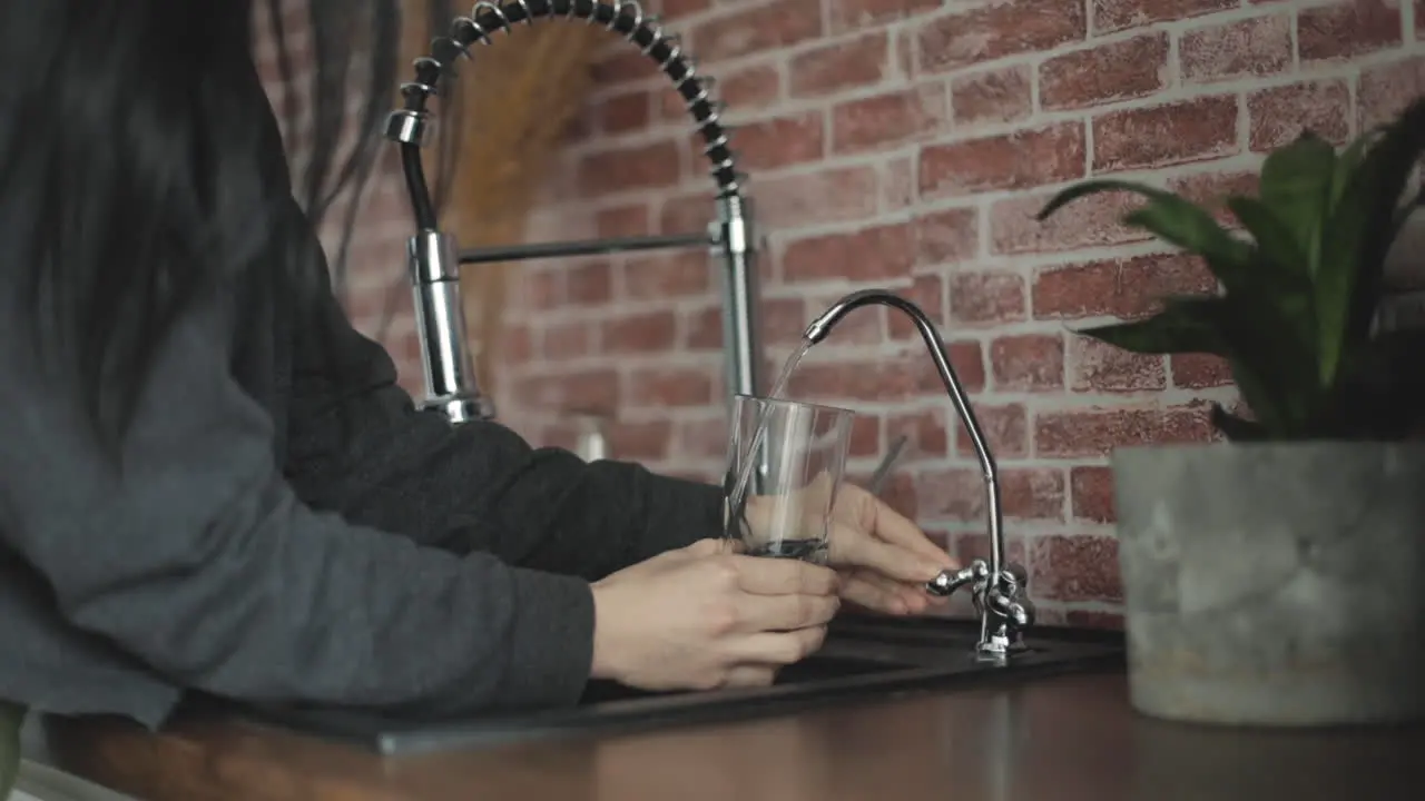 Filling Glass Of Water On The Kitchen Faucet