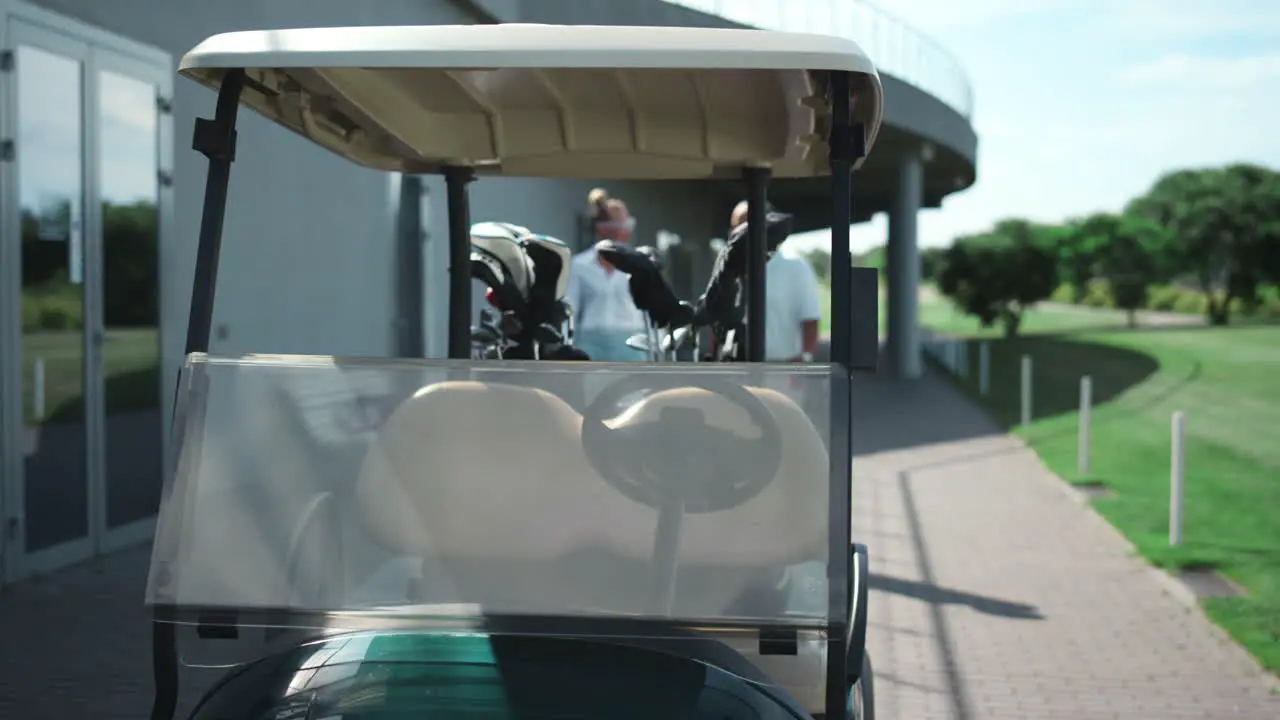 Golf players sit cart get ready outside Active couple going drive car on course