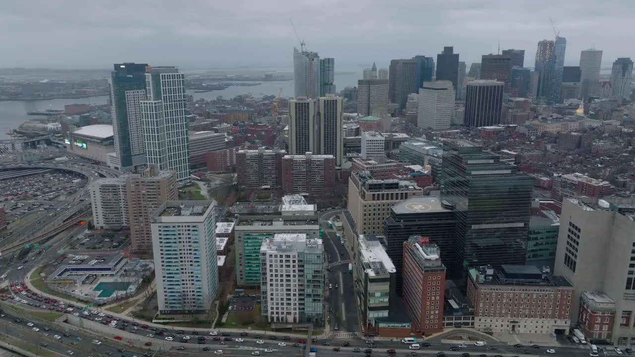 Aerial static shot of heavy traffic on roads in city Hospital and modern downtown high rise buildings Boston USA