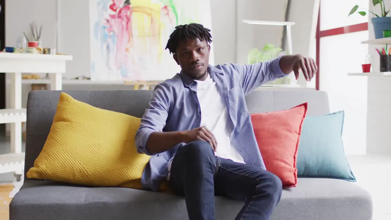 Portrait of african american male artist sitting on the couch at art studio