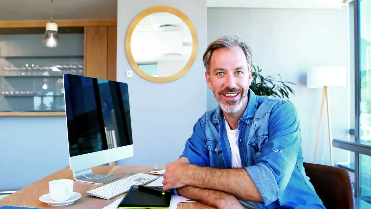 Portrait of graphic designer sitting at desk