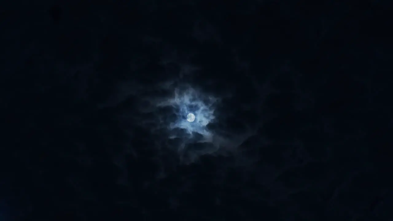 moon in the night sky with clouds