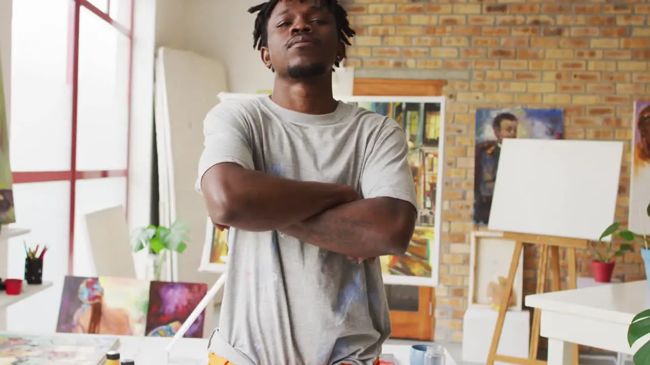 Portrait of african american male artist with arms crossed at art studio