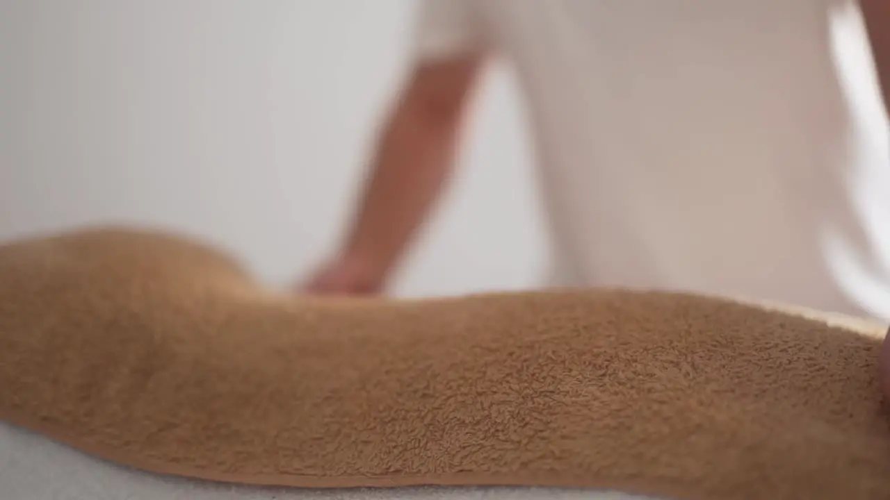 fiery kind of massage men's hands take a heated towel from the back closeup