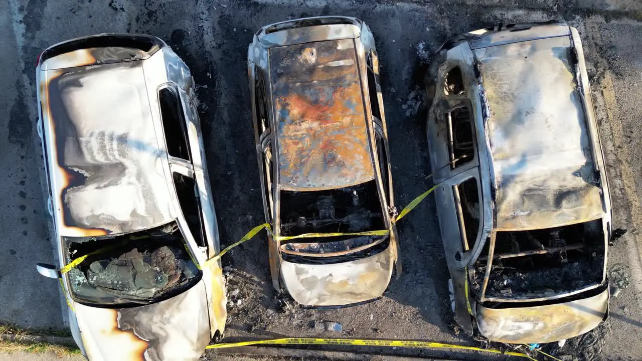 Burned cars in a city parking overhead aerial view