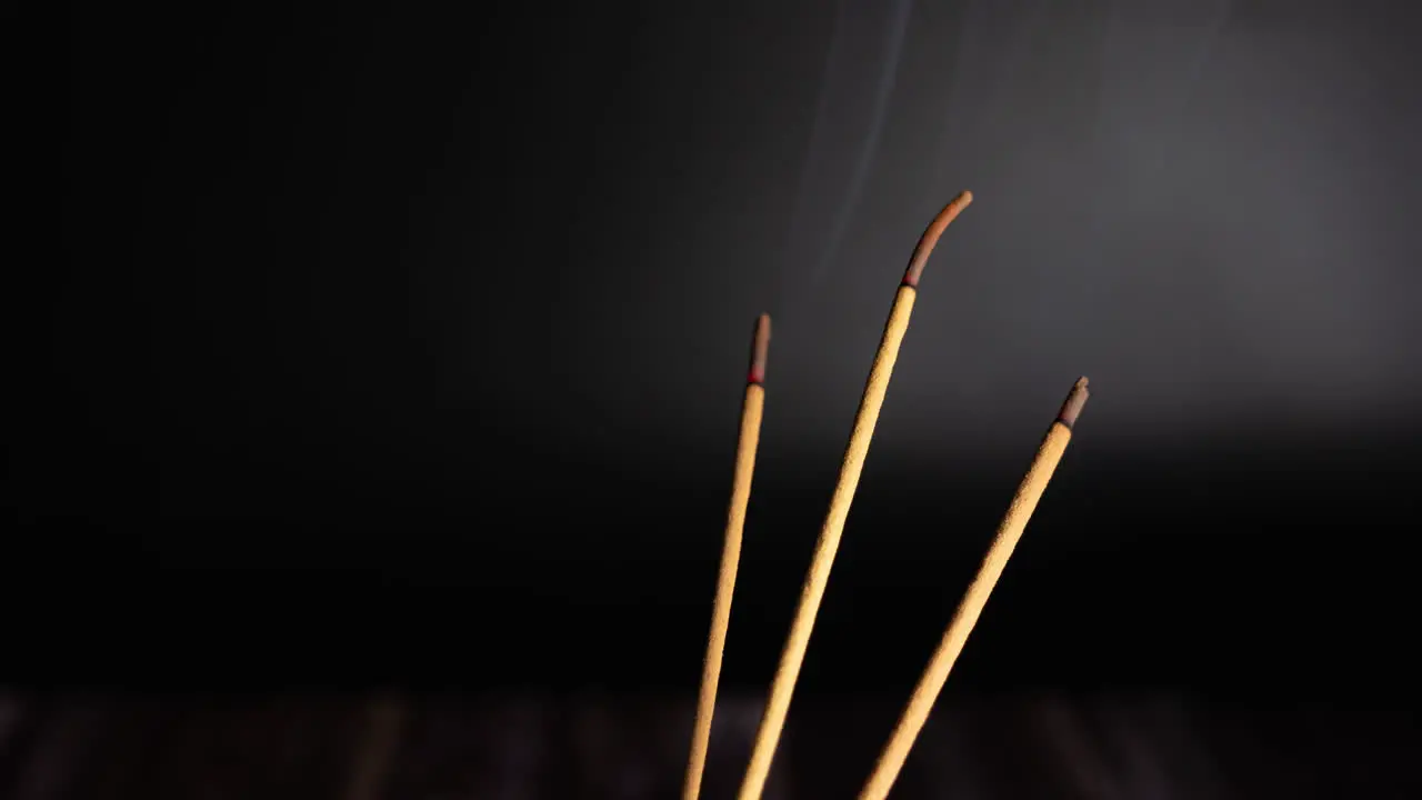 Time lapse of burning incense sticks also know as joss sticks