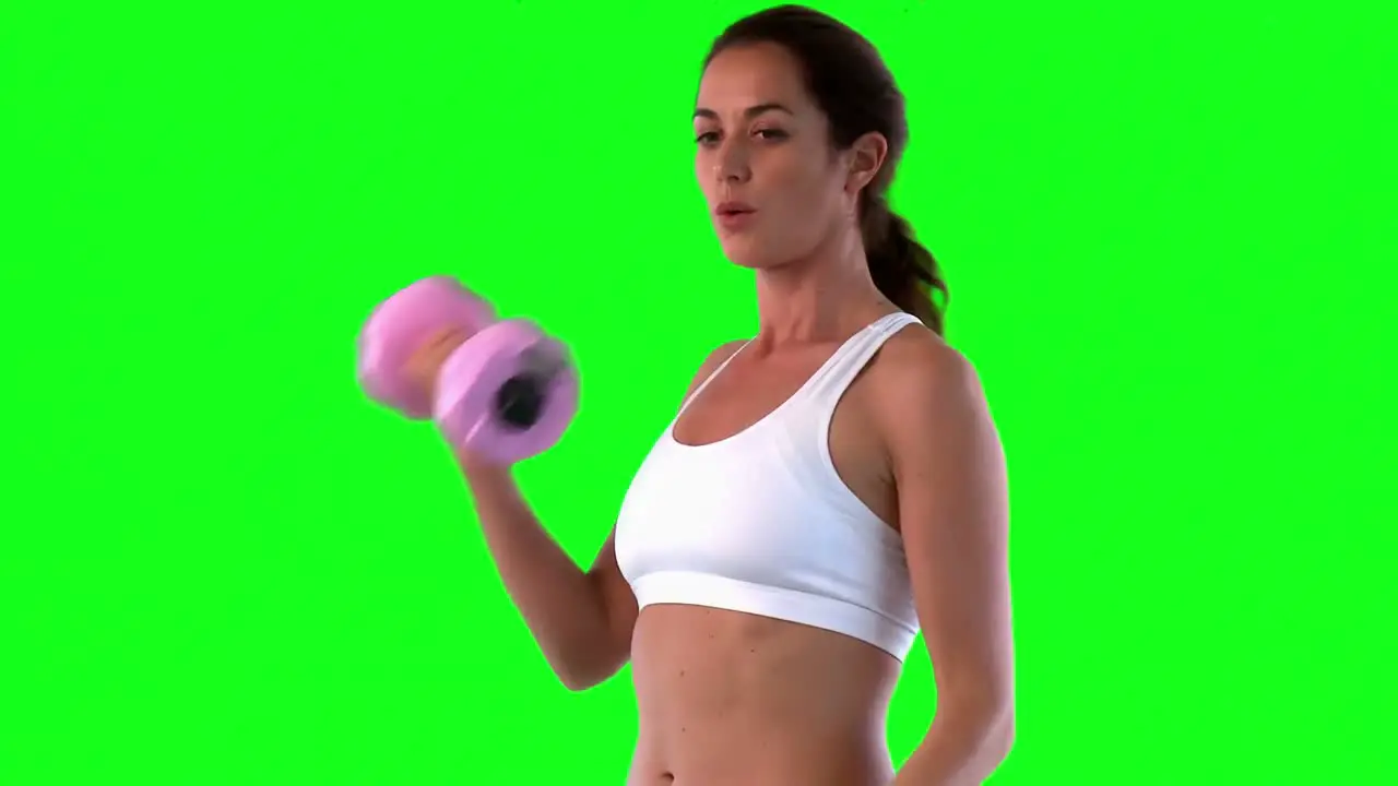 Athletic female exercising with dumbells 