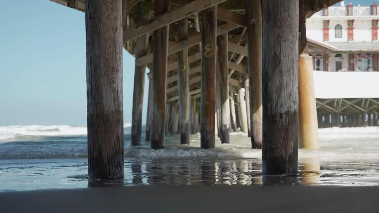 People walking under the pier structure