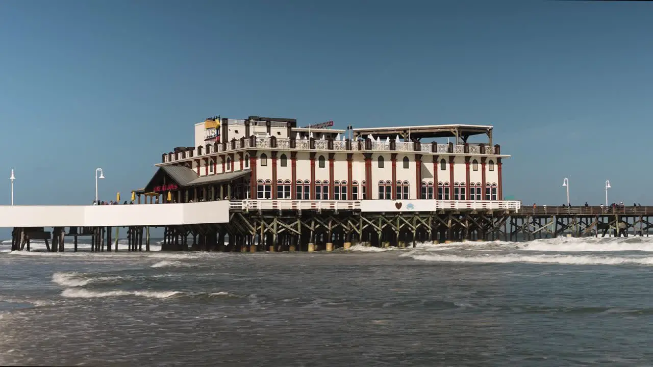 waves hitting the pier on a sunny day