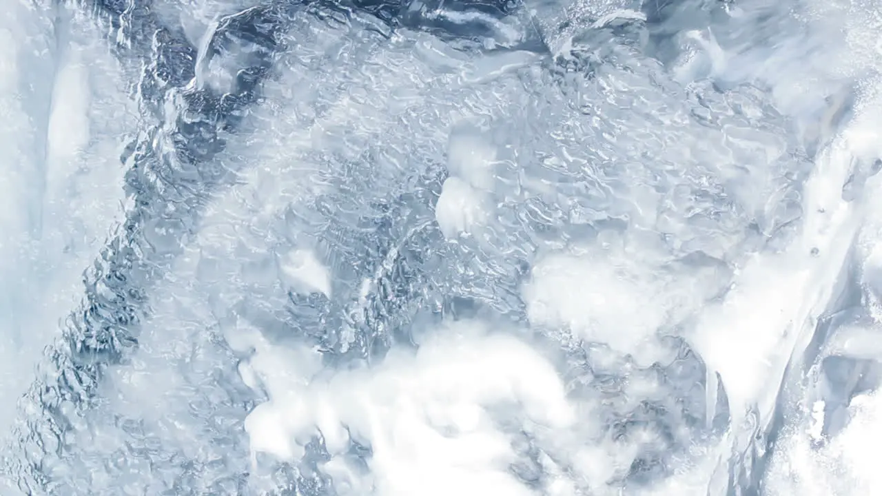 Water flowing under transparent ice surface Ice background Ice pattern