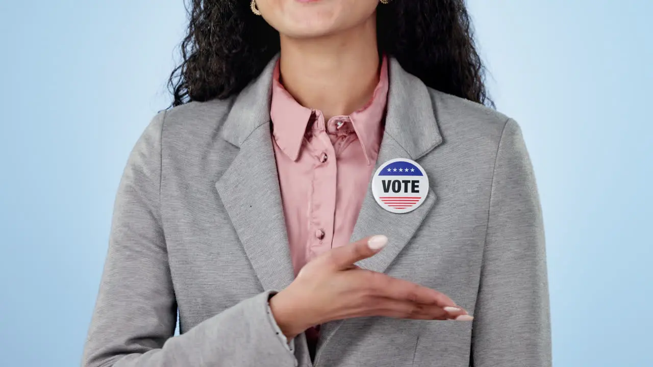 Woman in studio with pointing to vote