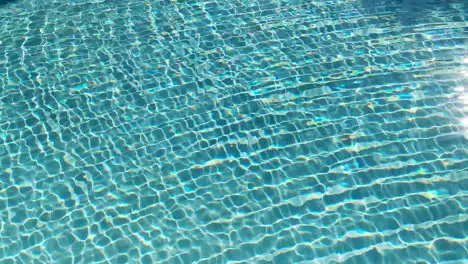 Water surface texture Slow motion looping clean swimming pool ripples and wave Refraction of sunlight top view texture sea side white sand sun shine water loop background