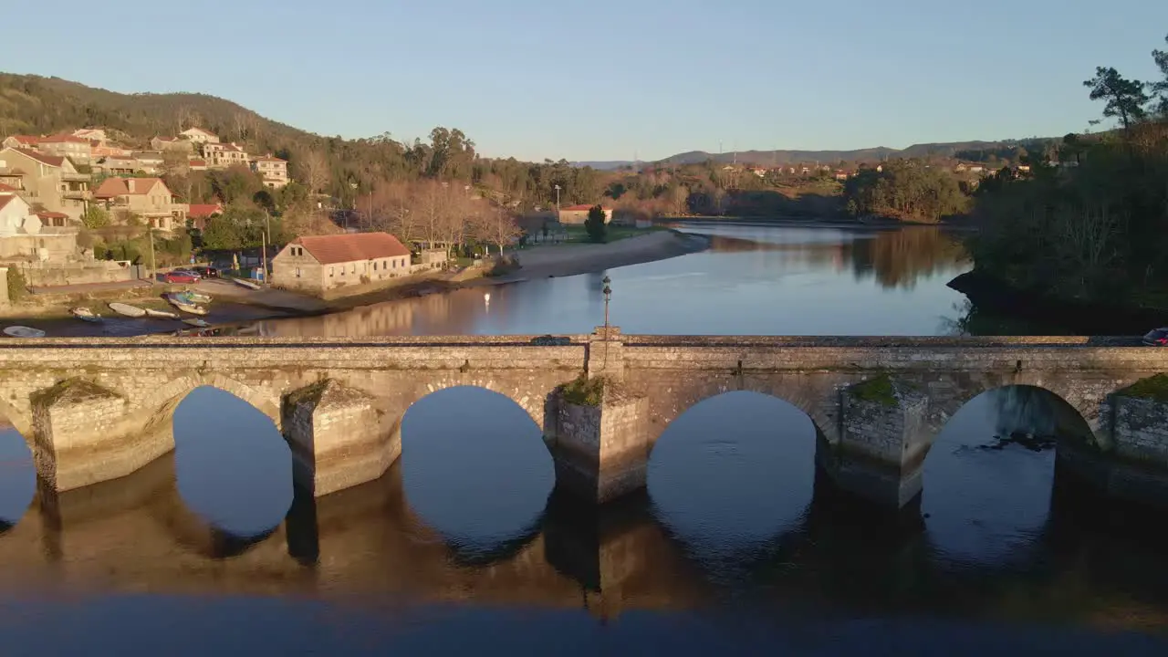 A wide shot was taken of a river where a car was seen moving over a bridge