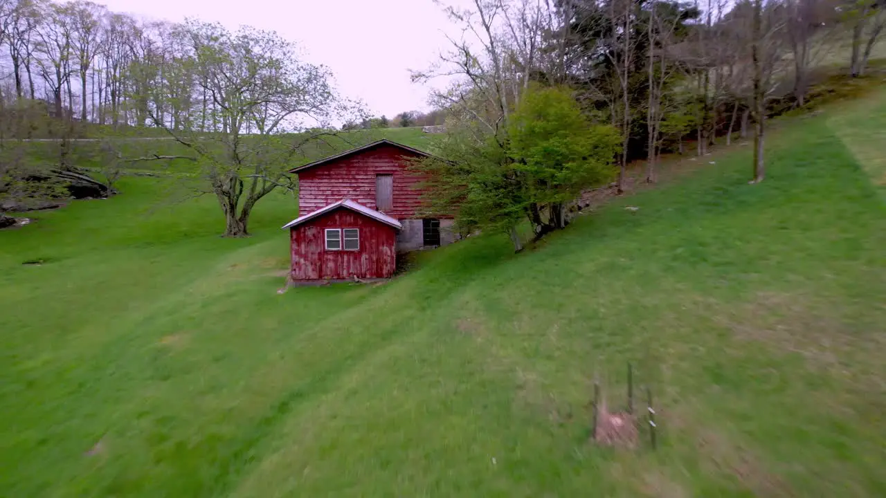 fast aerial push into red barn on farm near boone nc