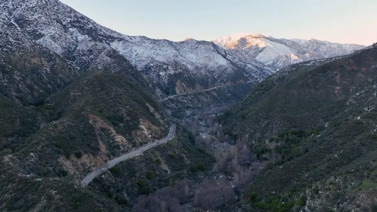 cars in the eoad driving on a big mountain with snow at Ontario Baldy Mountain