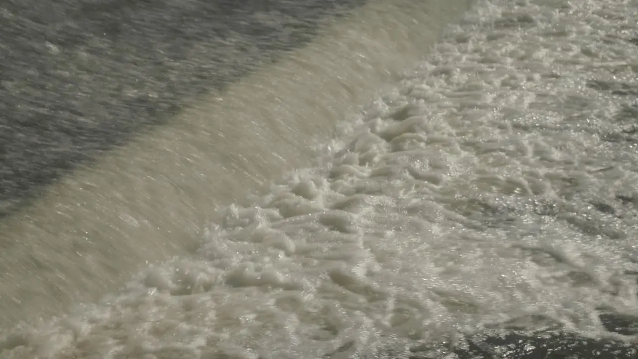 The fast splashing water stream of a weir