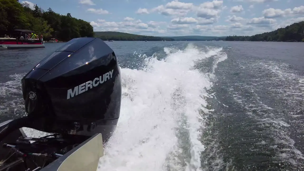 motor boat engine wake on a lake summer day