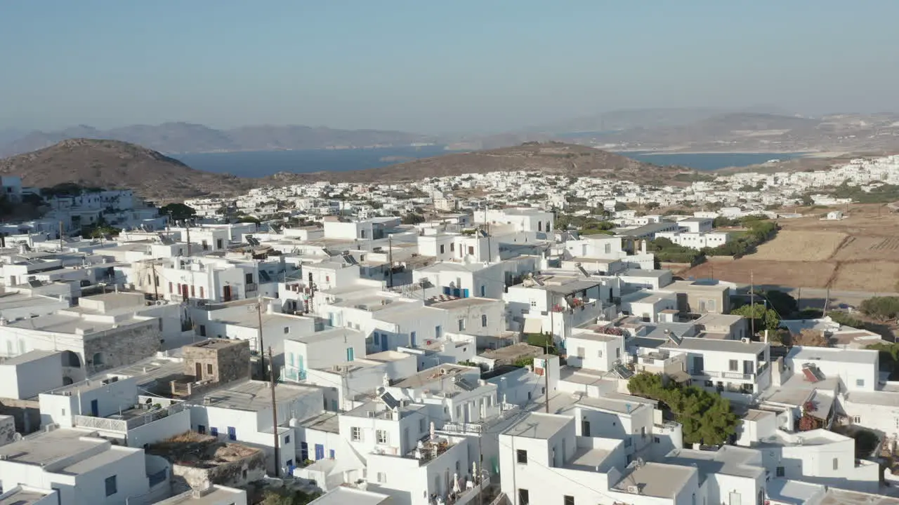 Wide Aerial View of Greek Village with White and Blue Houses