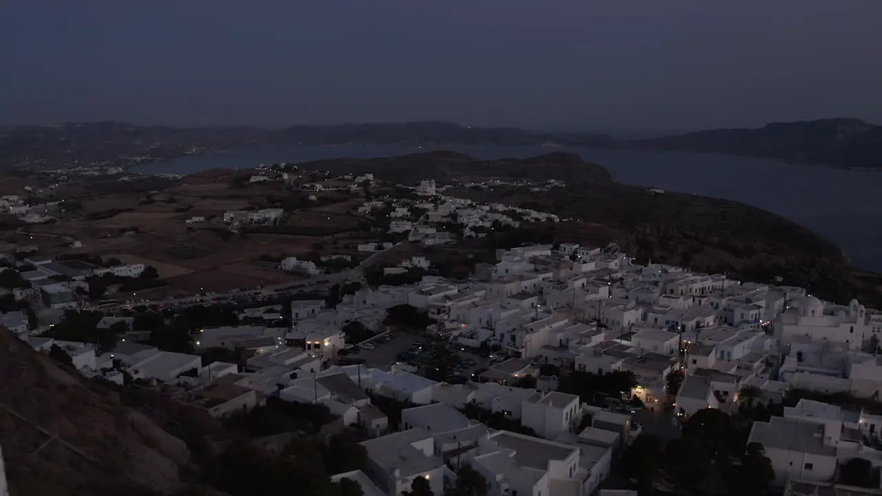 Little Village on a Mountain Site after Sunset with white Houses Aerial View