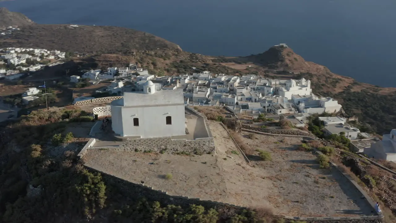 Church on top of the Hill with Greek Flag waving in wind Aerial Perspective