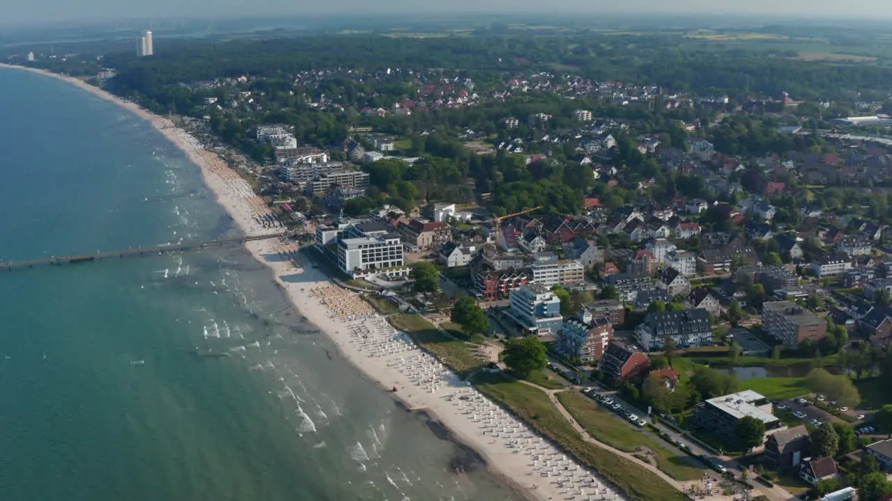 Baltic sea coastline in Scharbeutz Germany Aerial drone flying above tourist sea summertime beach dolly in day