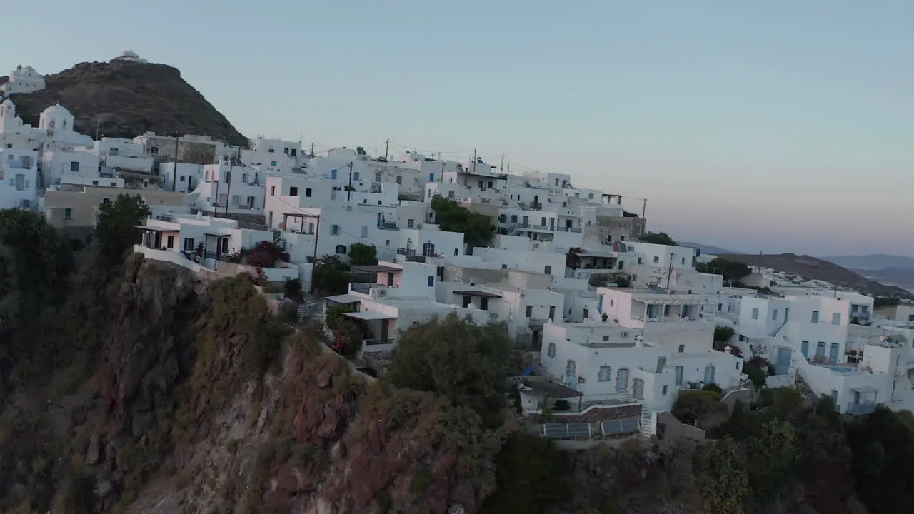 Aerial perspective over typically Greek Village Small Town on Island in Sunset Golden Hour Light