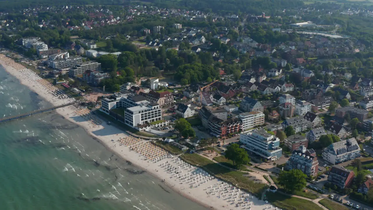 Beautiful high aerial drone view of tourist baltic sea beach in Scharbeutz Germany forward day